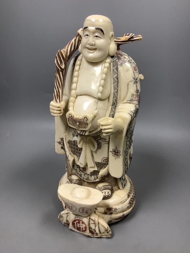 A Chinese engraved and stained bone figure of Budai, height 29cm